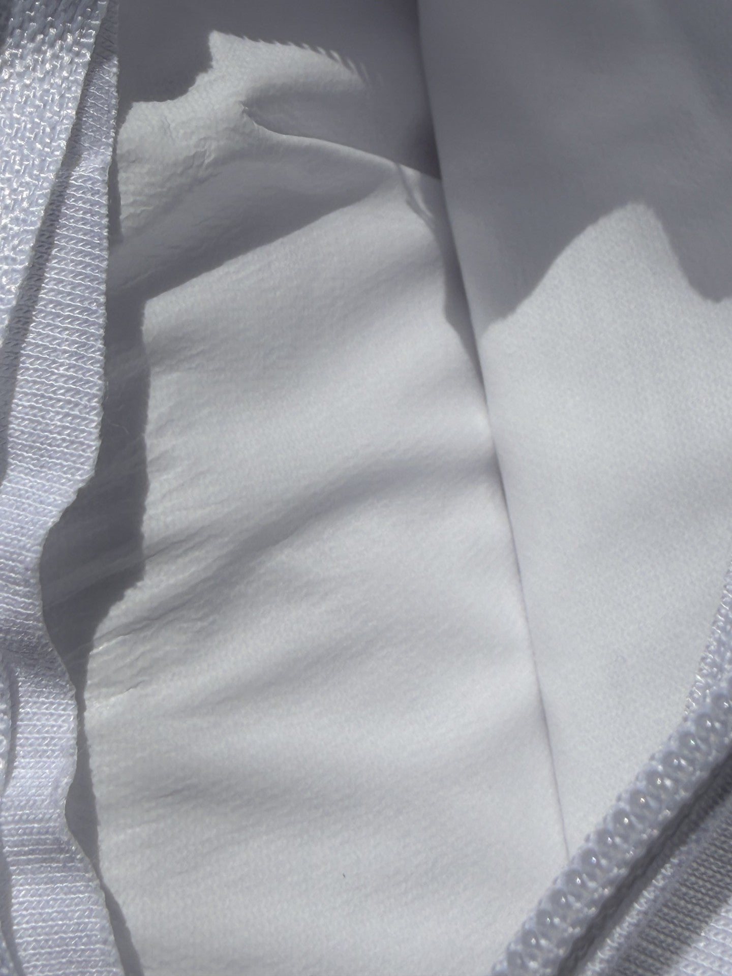 Waterproof protector turned back to show the membrane backing behind the jersey face
