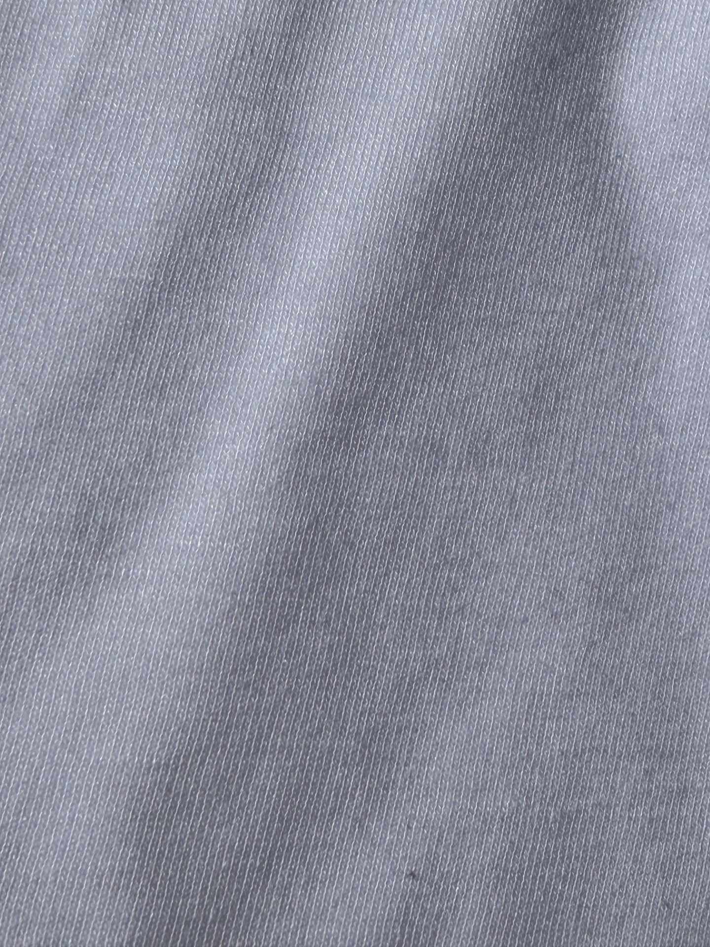 Close-up of the soft jersey-knit surface of a waterproof mattress protector